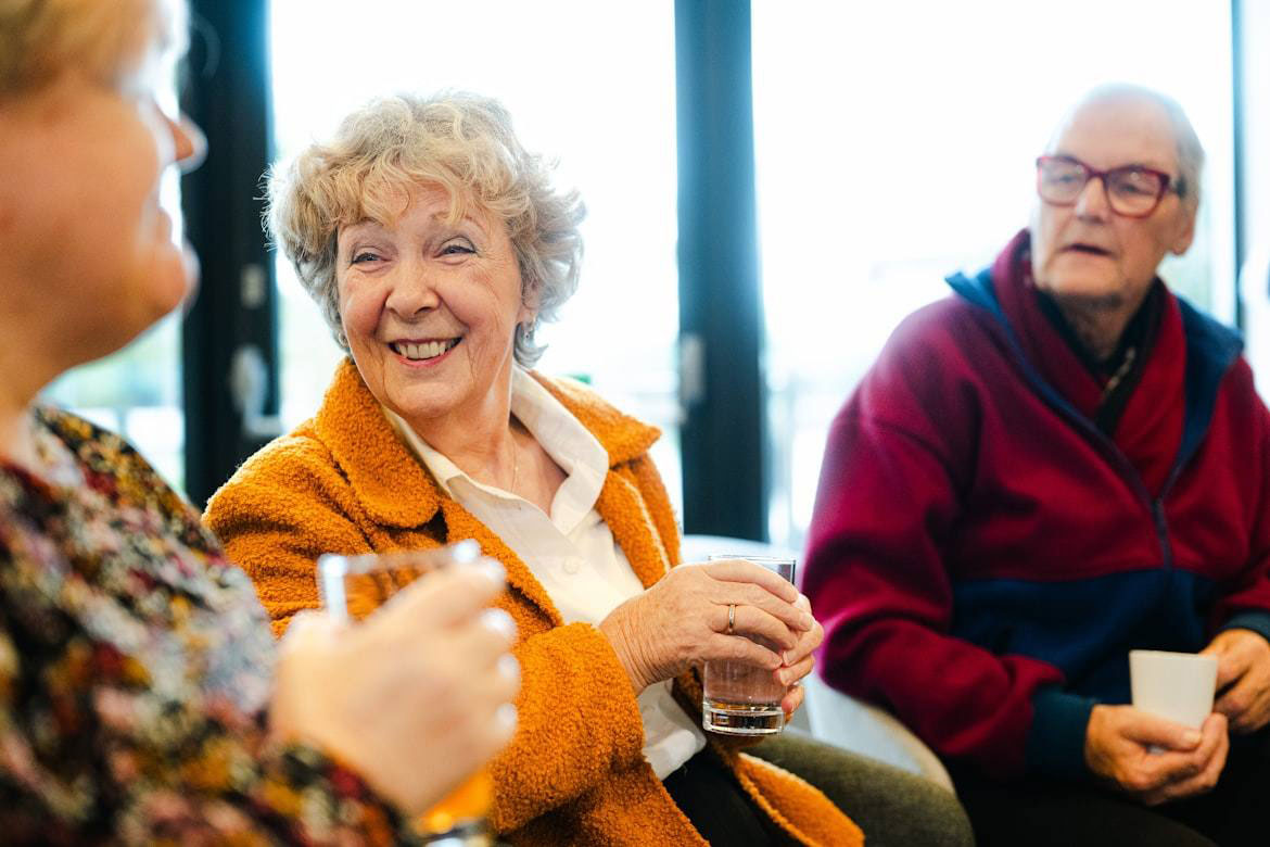 Retirement village tour: residents chatting together in the community lounge